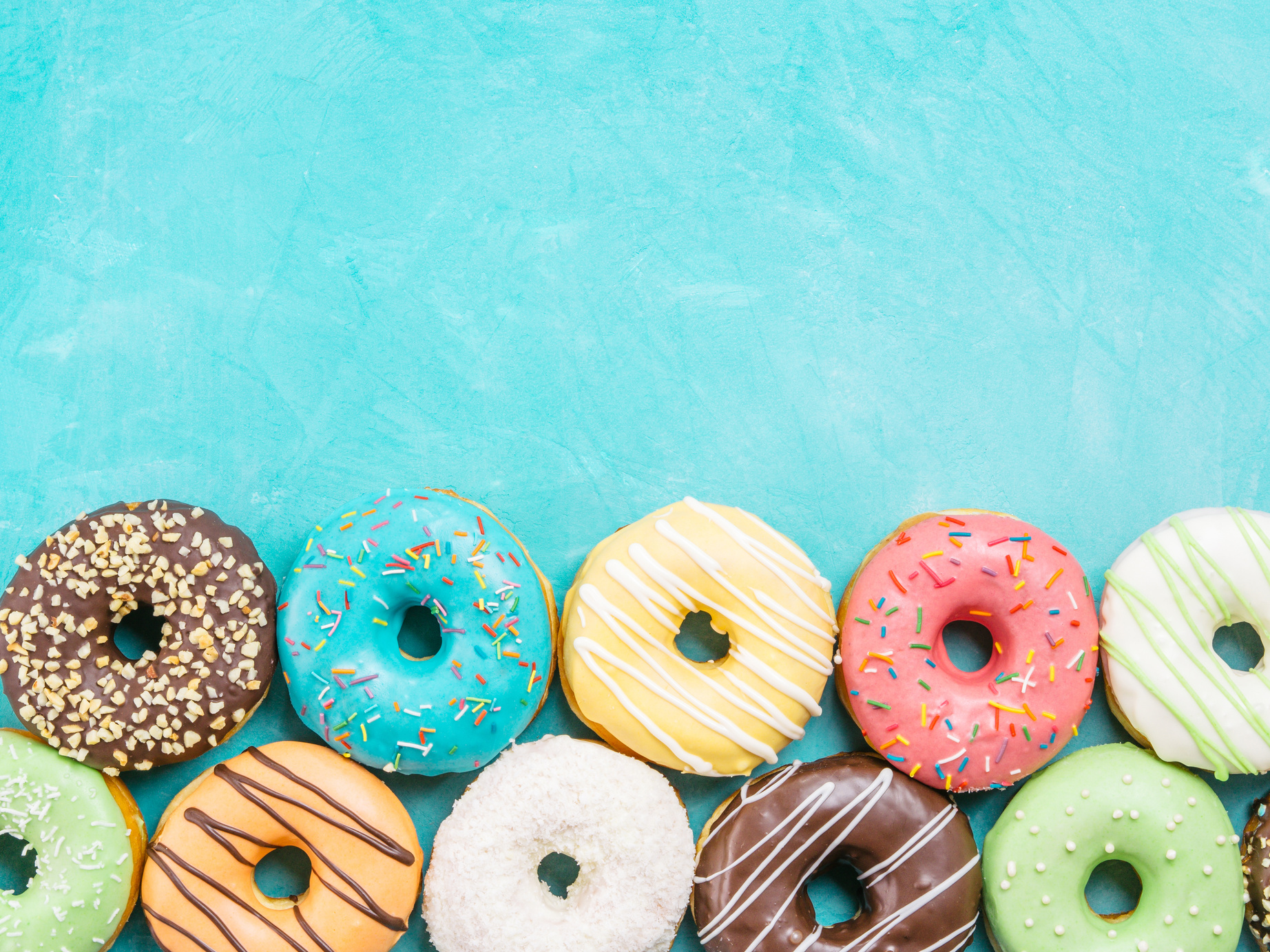 donuts on blue background , copy space, top view